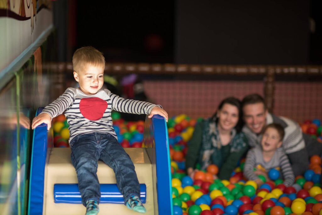 young parents with kids in a children's playroom